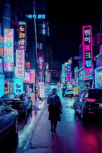 person walking in street during nighttime thumbnail