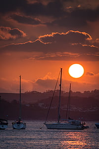 white motorboat on body of water during daytime sunset thumbnail