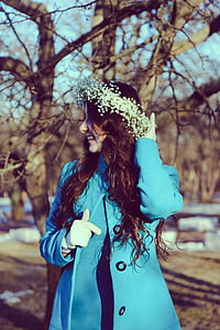 woman wearing white hair vine and blue coat thumbnail