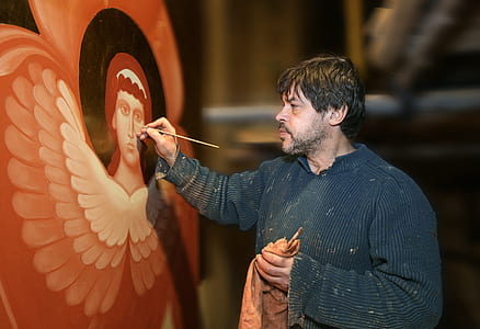 man painting religious woman on wall thumbnail