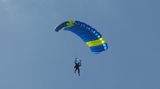 silhouette of a person paragliding in air during daytime thumbnail