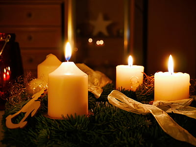 three white lighted candles thumbnail
