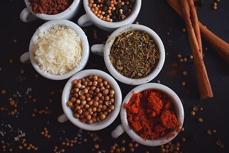 spices in white mugs on black surface closeup photography thumbnail
