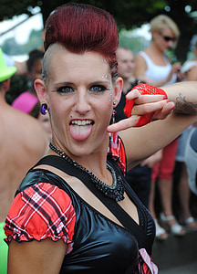 close-up photography of woman doing rock and roll hand posture with tongue out outdoors thumbnail