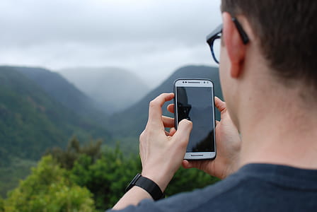 person holding turned off white Android smartphone thumbnail