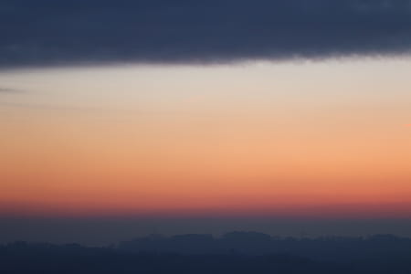 silhouette of mountains under orange sky at golden hour thumbnail