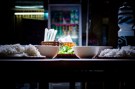 white ceramic bowl on brown wooden table thumbnail