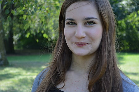 closeup photo of woman standing near tree thumbnail