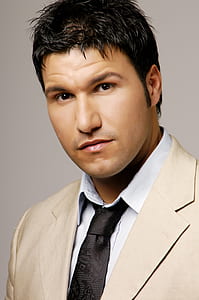 man wearing beige suit jacket and black necktie thumbnail