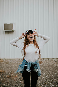 photo of woman holding curve-brimmed cap thumbnail