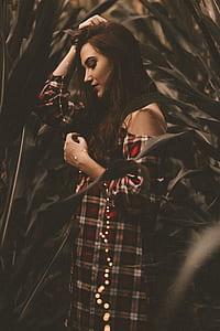 woman wearing white, red, and black off-shoulder dress in crop field thumbnail