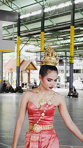 woman wearing pink dress and brass-colored crown thumbnail