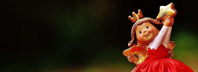 red dressed girl ceramic figurine macro photography thumbnail