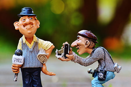 two male camera man and newscaster figurines thumbnail