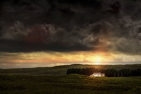 white house in the middle of green grass field thumbnail