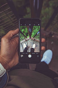 person holding black iPhone while using camera thumbnail