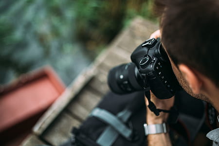 Photographer holding a DSLR camera thumbnail