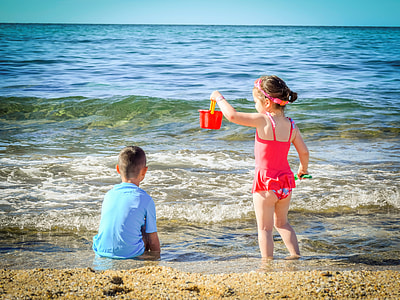 boy and girl playing on beach thumbnail