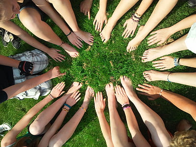 people hands and feet on green grass thumbnail