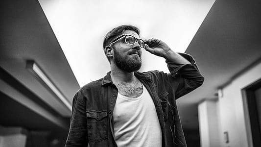 man holding his eyeglasses thumbnail