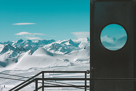 door near snowfield and mountains thumbnail