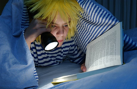 person holding flashlight and reading book thumbnail