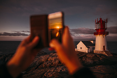 selective focus photography of red and white lighthouse thumbnail