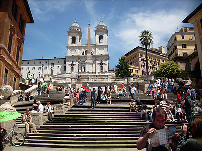 people walking on gray concrete stairs near concrete buildings thumbnail