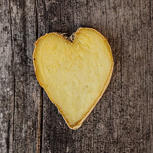heart-shaped ginger root on brown wooden surface thumbnail