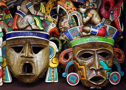 two brown wooden masks on brown surface thumbnail