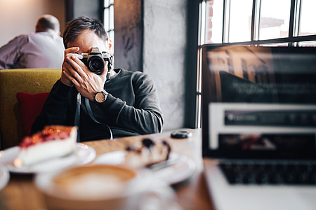 Young Elegantly dressed man sititng in a cafe thumbnail