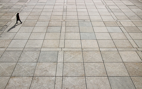 man walking on brown floor thumbnail