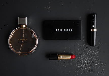 flat lay photography of four cosmetic products thumbnail