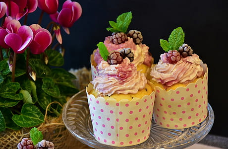 three cupcakes with white polka-dot cover on clear glass saucer thumbnail