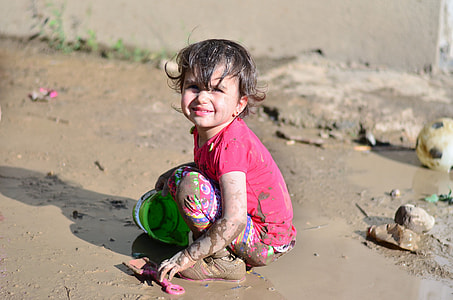 girl holding green plastic buckjet \ thumbnail