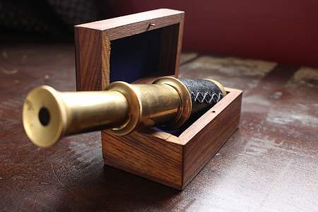 brass-colored and black telescope on brown wooden case thumbnail