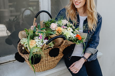 Young woman with basket full of flowers thumbnail