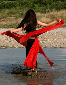 woman wearing black and red dress on brown body of water thumbnail