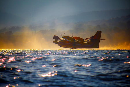 red and white plane on body of water thumbnail