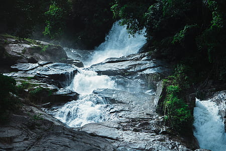 Photography of Waterfalls Near Trees thumbnail