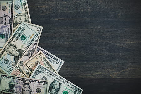 Cash Money Bills On Woodgrain Photo thumbnail