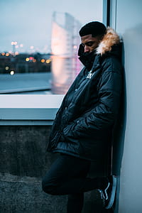 man standing near to wall thumbnail