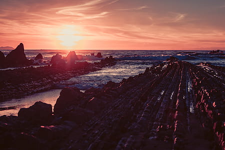 rock formations and sea during sunset thumbnail