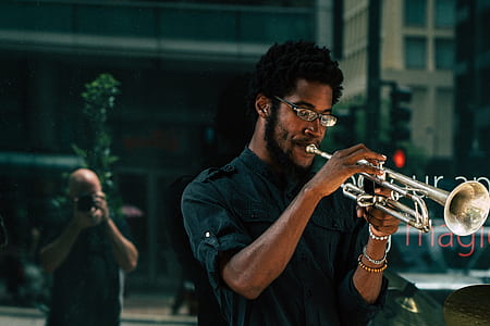 man wearing black dress shirt playing silver trumpet thumbnail