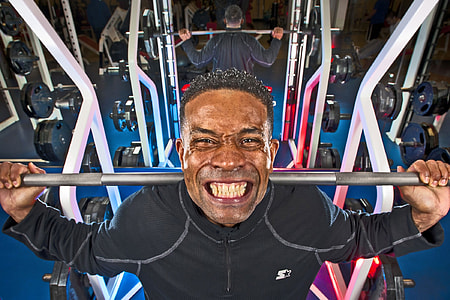 man lifting dumbbell in gym thumbnail