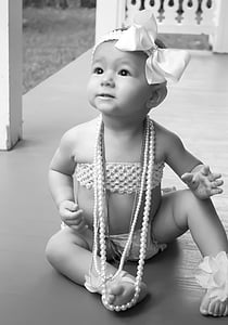 grayscale picture of baby sitting on the floor thumbnail
