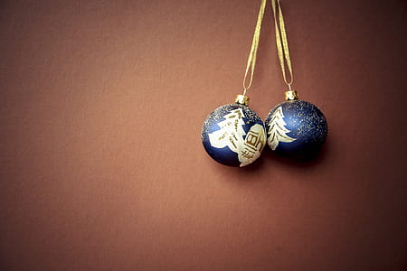 two blue-and-white baubles on brown surface thumbnail