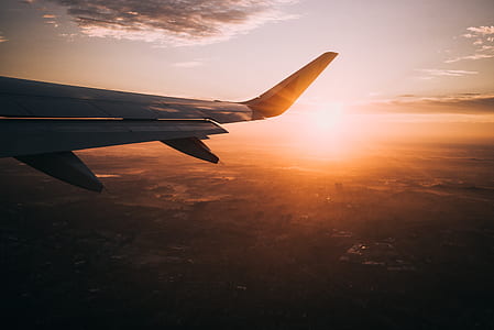 golden hour photography of aircraft wing and landscape thumbnail