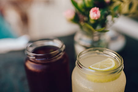 Clear Glass Mason Jar With Lemon Slice on Top of Cocktail thumbnail