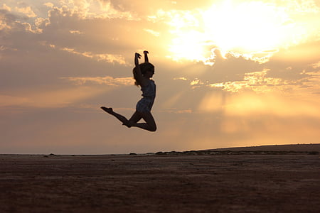 woman jumping during sunset thumbnail